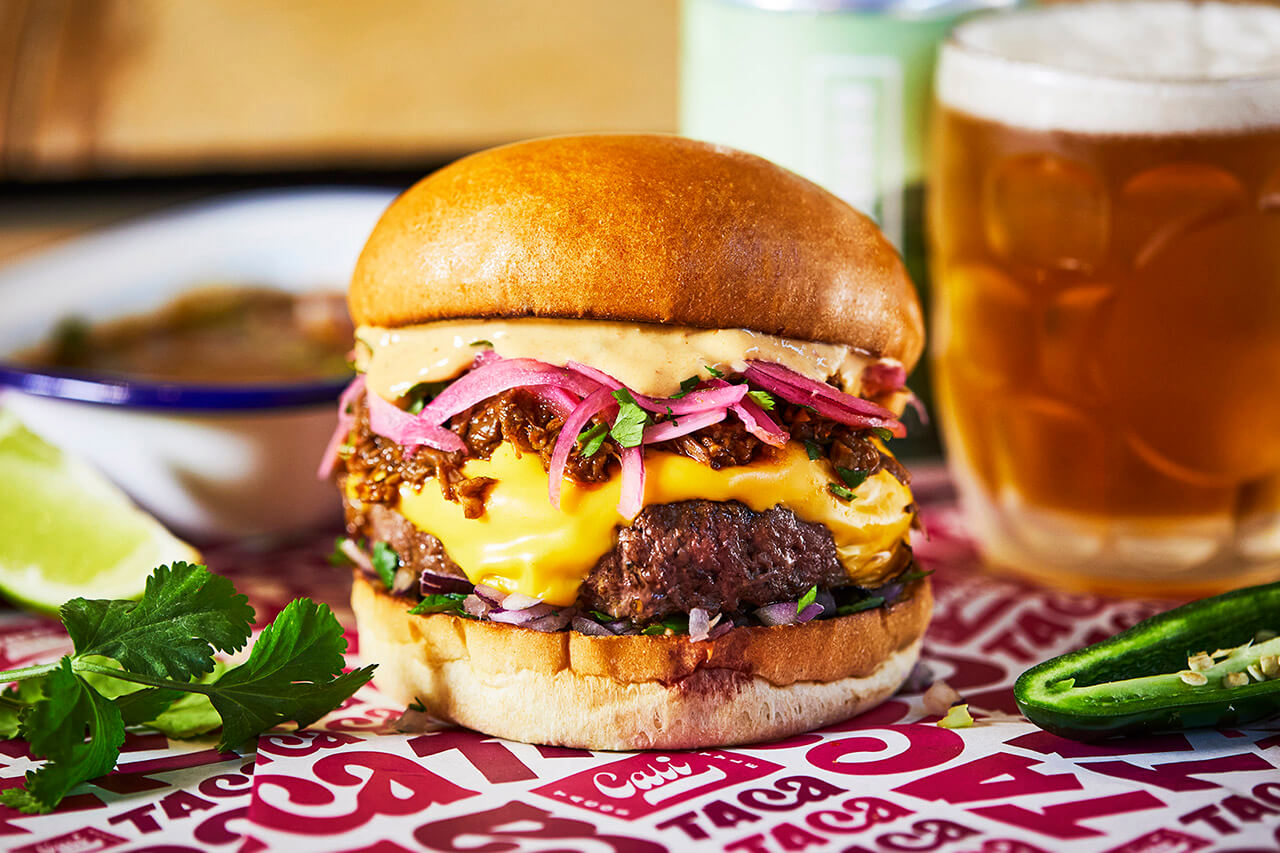 A beef birria burger with braised Mexican beef and dipping broth