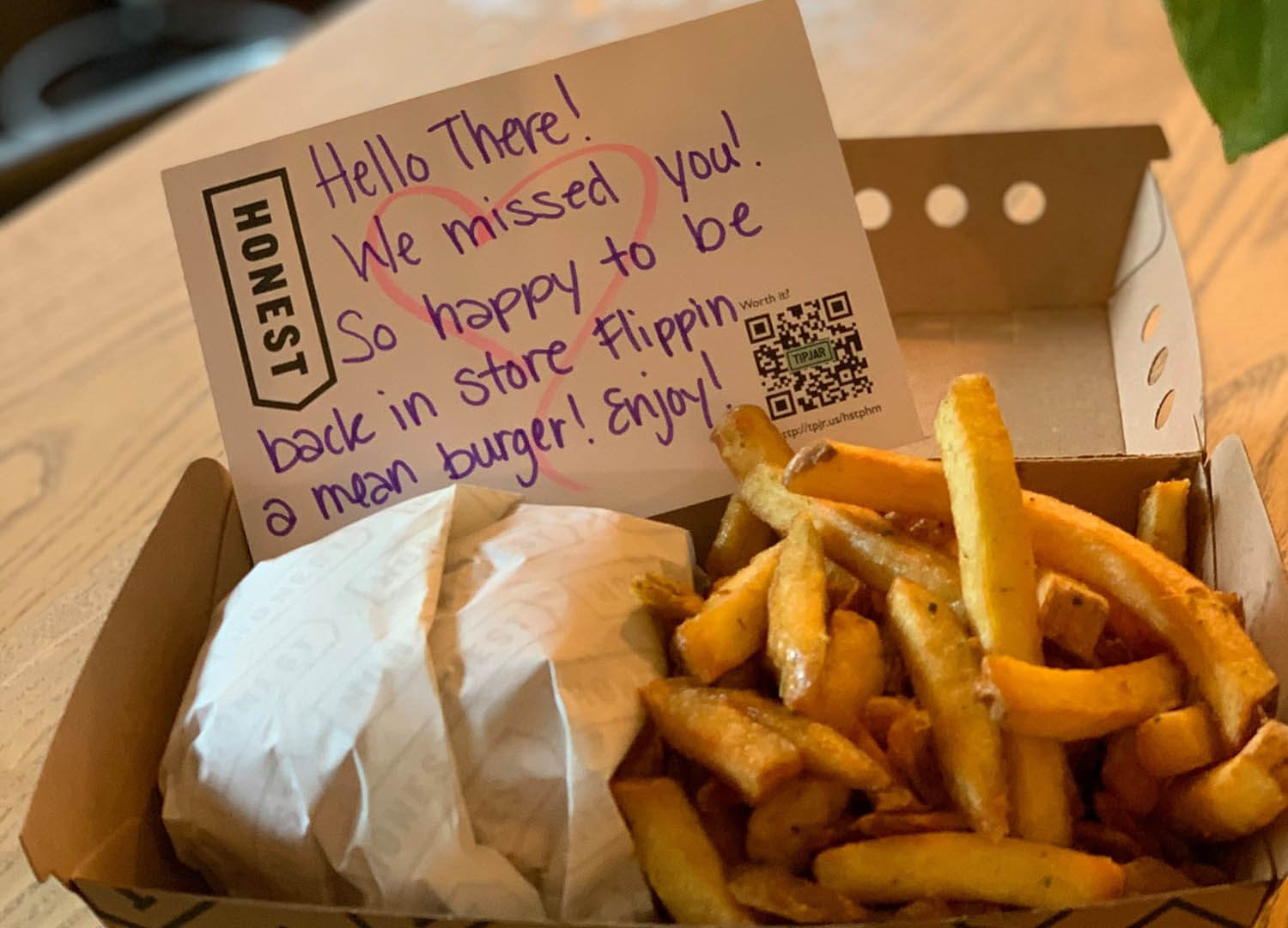 Honest Burgers takeout box, with burger, chips and a thankyou note