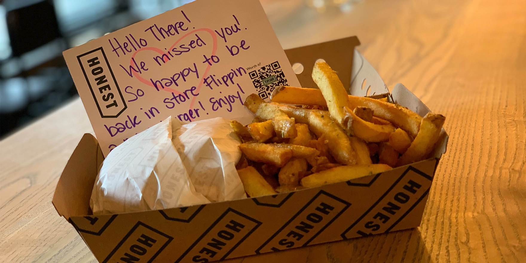 Honest Burgers takeout box, with burger, chips and a thankyou note