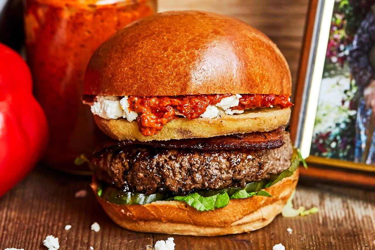 Beef burger with bacon, feta, red pepper and aubergine