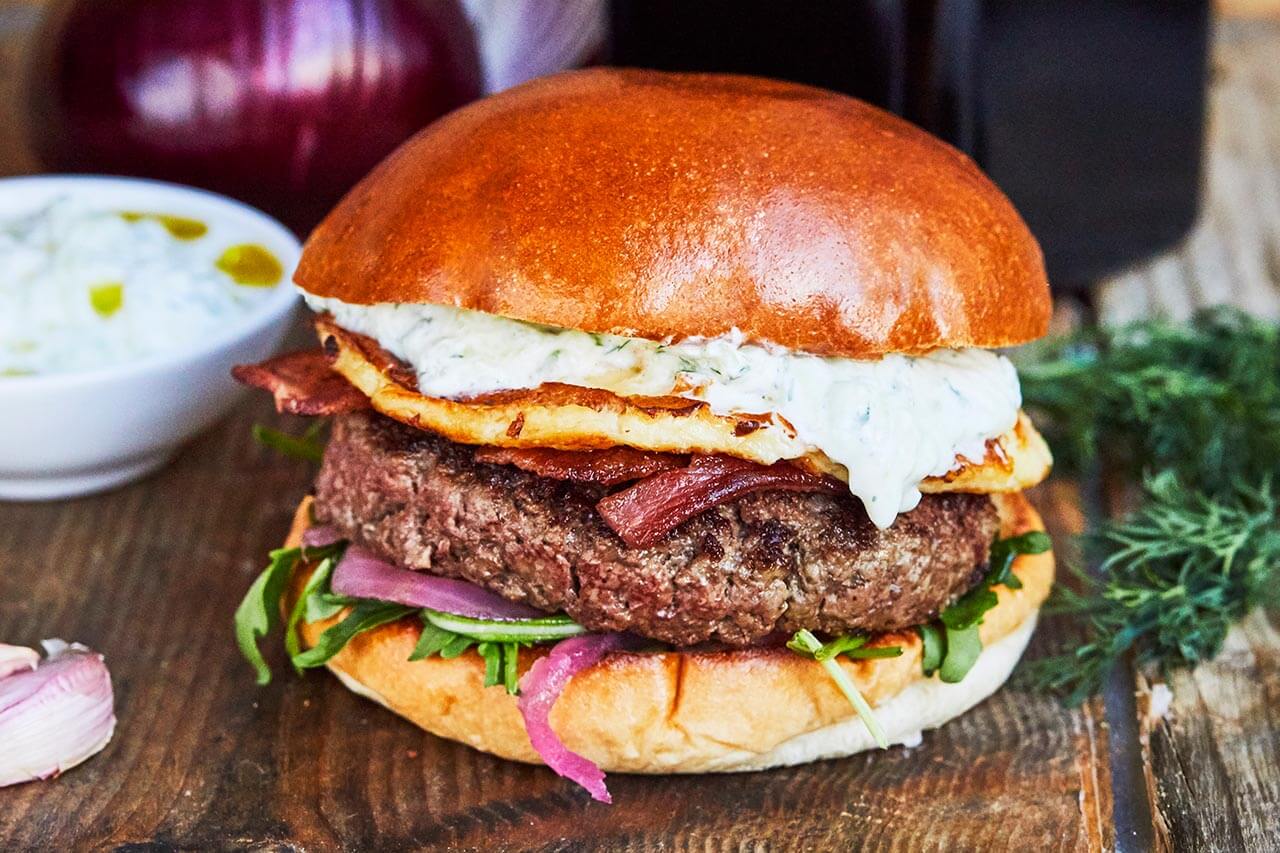 Honest beef, bacon, halloumi, family recipe tzatziki, pink pickled onions and rocket with homemade rosemary salted chips