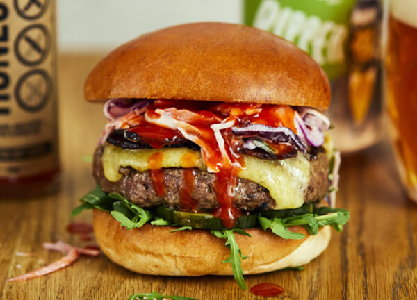 Brighton - A beef burger with bacon, Smoked Mayfield cheese, Honest X Brighton Hot habanero sauce, chipotle slaw, rocket, and pickles with rosemary chips
