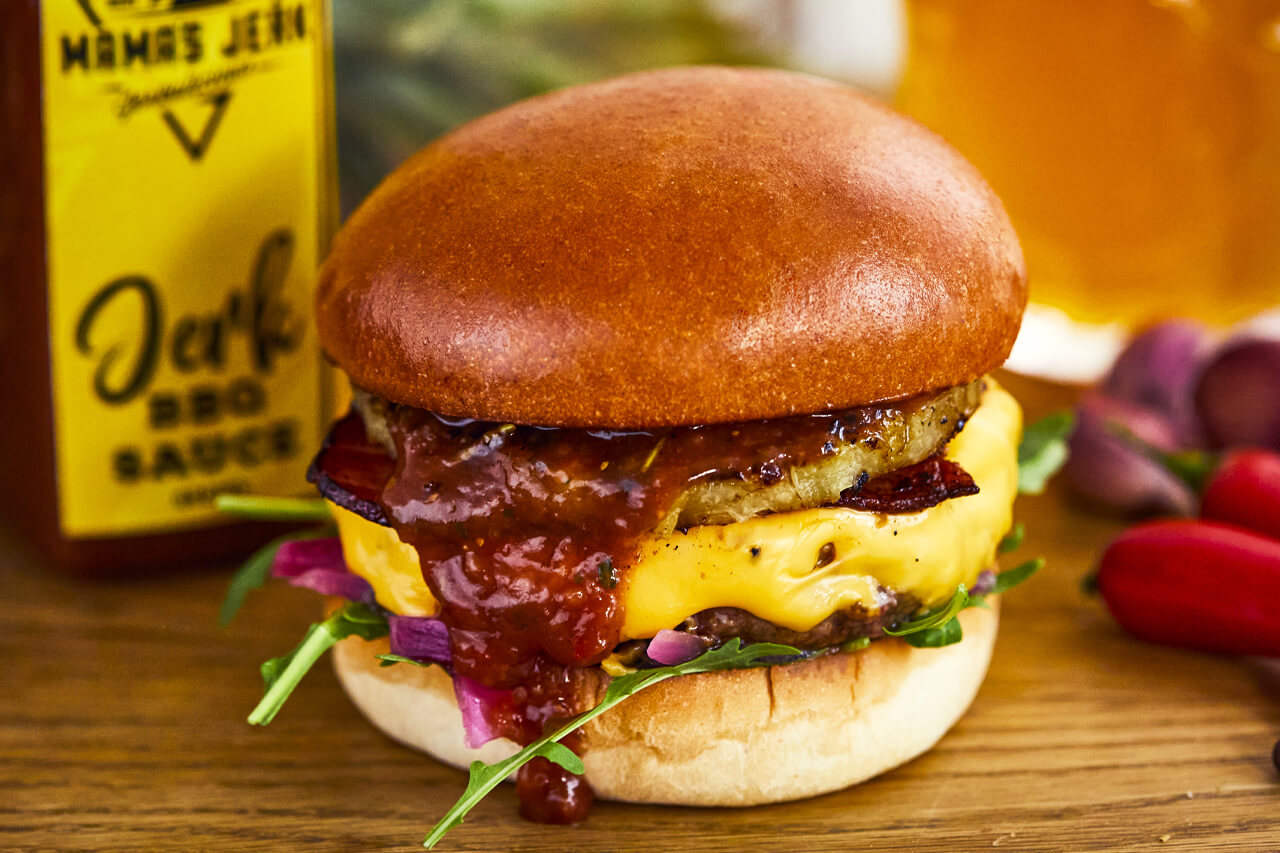 Brixton Jerk- A beef burger with bacon, double American cheese, Jerk BBQ sauce, grilled pineapple, rocket, pink pickled onions with rosemary chips