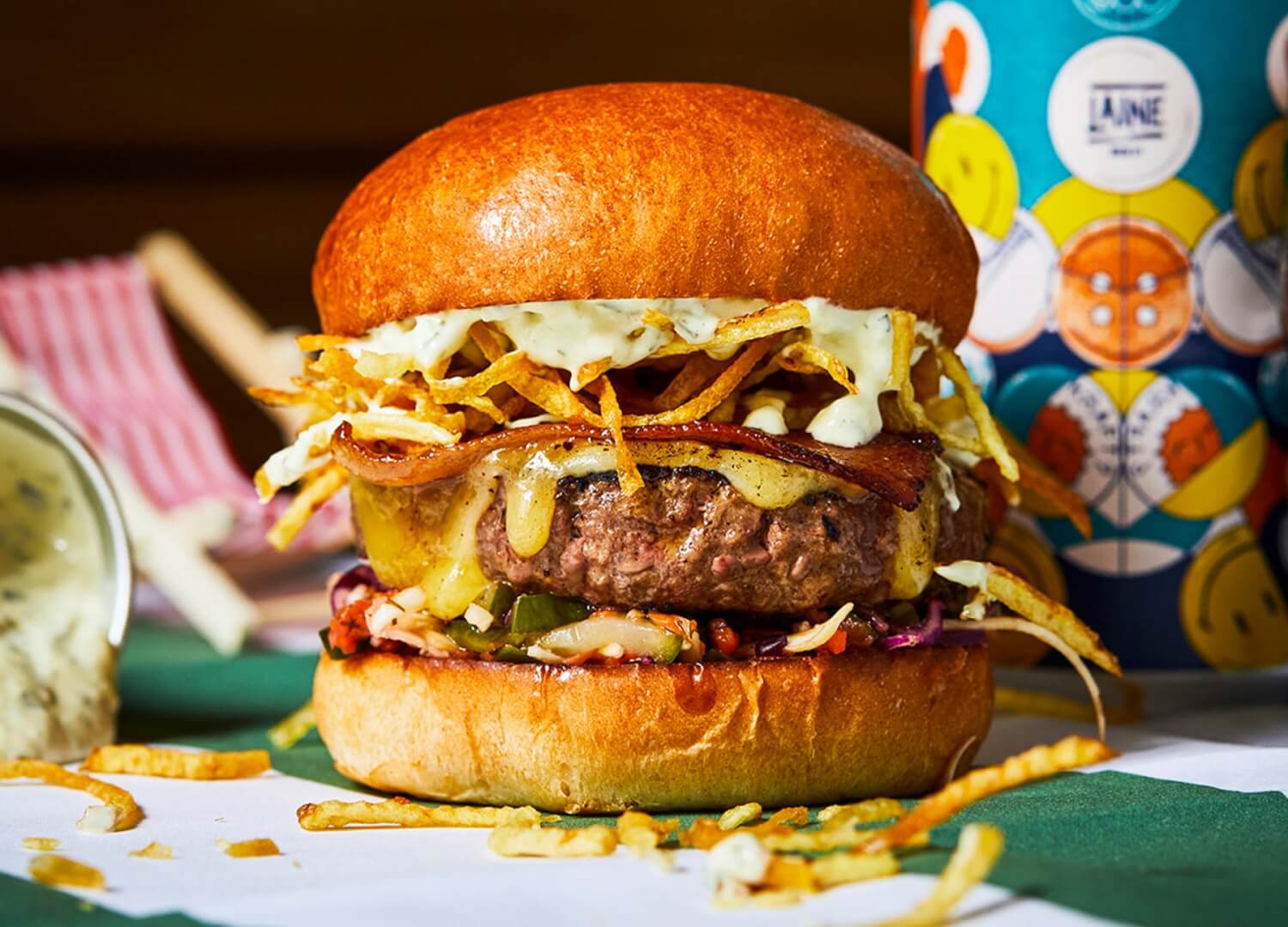 A new burger just for The Fortune of War on Brighton beach - beef, candied bacon, cheese, shoestring fries, garlic mayo and slaw with chips