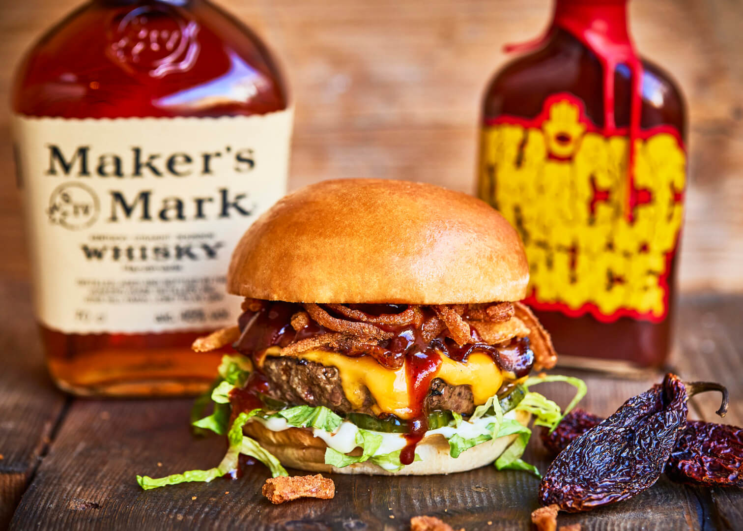 A burger featuring Bourbon BBQ Sriracha sauce from Thiccc Sauce
