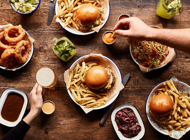 Burgers and sides on table